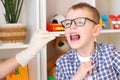 Speech Therapy.Boy learn to pronounce letters, words, sounds correctly in front of a mirror