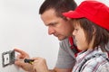 Boy learning how to fix an electrical wall fixture