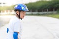 Boy learning skating outdoor, sweats on his face..