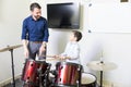 Boy Learning To Play Drum From Talented Music Instructor