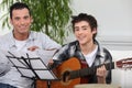 Boy learning to play the guitar