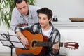 Boy learning to play the guitar