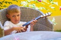 Boy learning to play the kid`s guitar Royalty Free Stock Photo