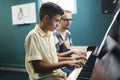 Boy learning to play the piano with teacher Royalty Free Stock Photo