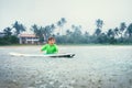 Boy learning to surf under the rain Royalty Free Stock Photo