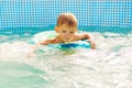 Boy Learning to Swim in Pool with Float Ring Royalty Free Stock Photo