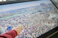 A boy in learning Tokyo city map through very big touch screen