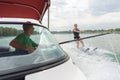 Boy learning waterski with instructor on boat