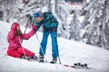 Boy learning young girl skiing on snow Royalty Free Stock Photo
