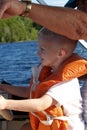 Boy learns to drive the boat Royalty Free Stock Photo
