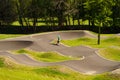 The boy learns to ride a skateboard on a special track. Royalty Free Stock Photo