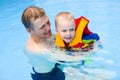 Boy learns to swim in pool with father Royalty Free Stock Photo