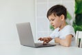 Little boy learns to work on a laptop Royalty Free Stock Photo