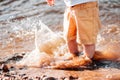 Boy leg in the river. water splashes