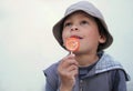 Boy licking a sweet lollipop stock photo Royalty Free Stock Photo
