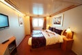 Boy lies on bed in ship cabin general view Royalty Free Stock Photo