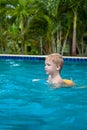 Boy in a life jacket have fun in the swimming pool Royalty Free Stock Photo