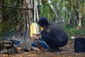 Boy lighting a camp fire. Royalty Free Stock Photo