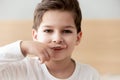 Boy like adult drew moustache on finger put over lips Royalty Free Stock Photo