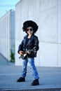 A boy like a rock star playing music on electric guitar. Royalty Free Stock Photo