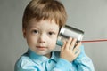 Boy listen tin can telephone Royalty Free Stock Photo