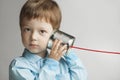 Boy listen tin can telephone Royalty Free Stock Photo