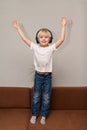 Boy listening to music and dancing with their hands up. Vertical frame Royalty Free Stock Photo