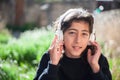 Boy listening to music with white headphones.