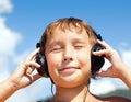 Boy listens to music on headphones Royalty Free Stock Photo