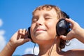 Boy listens to music on headphones Royalty Free Stock Photo