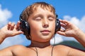 Boy listens to music on headphones Royalty Free Stock Photo