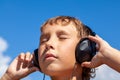 Boy listens to music on headphones Royalty Free Stock Photo