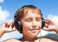 Boy listens to music on headphones Royalty Free Stock Photo