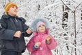 Boy and little girl with petard in hands in winter