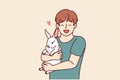 Boy with little rabbit laugh hugging beloved pet for concept of love for domestic animals