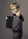 Boy little smart child in glasses showing blank card certificate