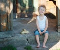 Boy with little yellow duckling in summer village Royalty Free Stock Photo