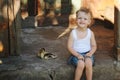 Boy with little yellow duckling in summer village Royalty Free Stock Photo