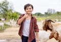 The boy lives in the countryside by raising goats