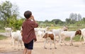 The boy lives in the countryside by raising goats