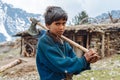 Boy living in the Himalayas holding an axe Royalty Free Stock Photo