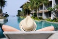 Boy on the longue chair near the swimming pool relaxing. Travel concept, travelling, hotel business.