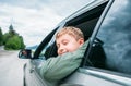 Boy look out from the car window Royalty Free Stock Photo