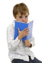 Boy looking from above a book