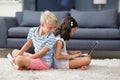 Boy looking behind while his sister using laptop in living room Royalty Free Stock Photo