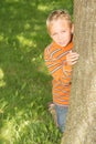 Boy Looking From Behind a Tree Royalty Free Stock Photo