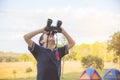 Boy looking by binoculars at camping site Royalty Free Stock Photo