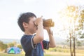 Boy looking by binoculars at camping site Royalty Free Stock Photo