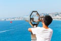 Nice, France - 16.09.16: Boy looking through binoculars on a flying parachute in a beautiful sea in Nice,France .