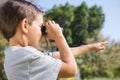 Boy looking through binoculars and pointing Royalty Free Stock Photo